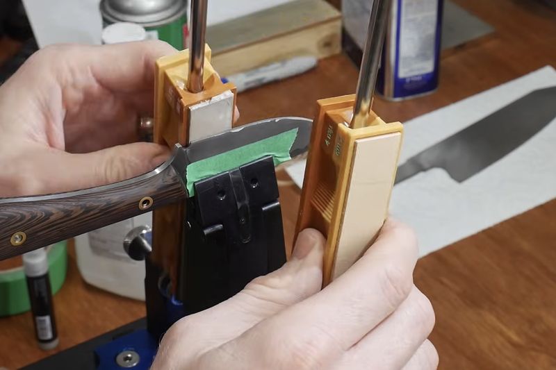 Sharpening a chef knife by hand on a stone